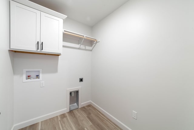 laundry area featuring hookup for a washing machine, baseboards, hookup for an electric dryer, light wood-style flooring, and cabinet space