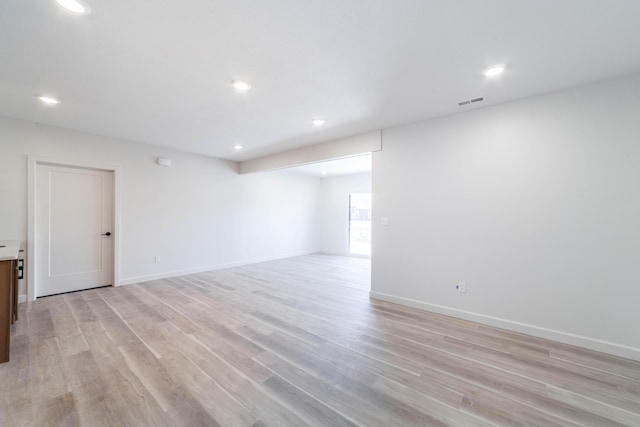 unfurnished room with recessed lighting, baseboards, and light wood finished floors