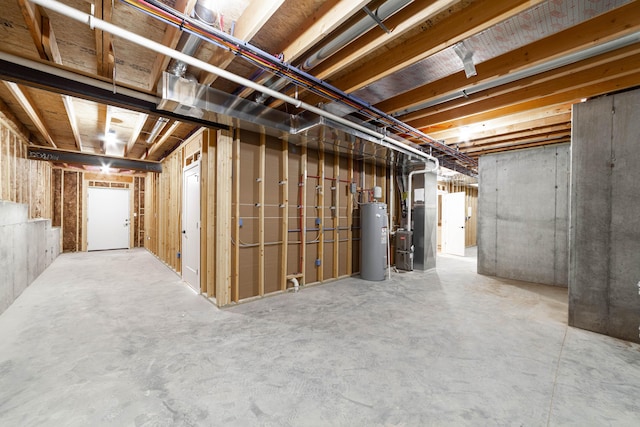 unfinished below grade area featuring electric water heater