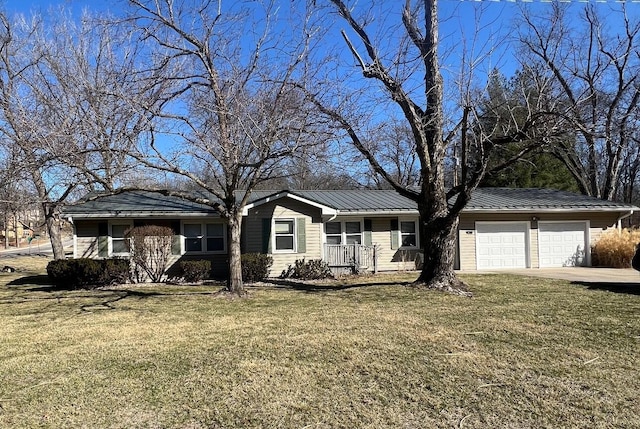 single story home featuring a front yard, an attached garage, concrete driveway, and metal roof