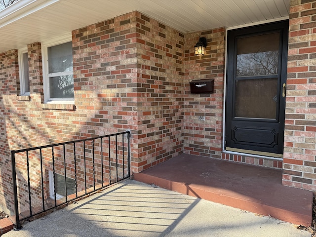 property entrance with brick siding