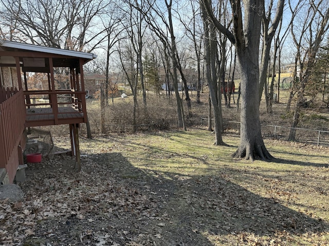 view of yard featuring a deck and fence