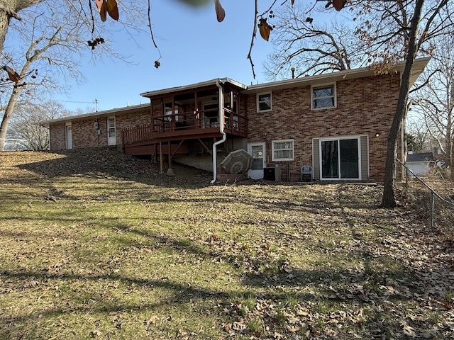 back of property with central air condition unit, brick siding, and a deck