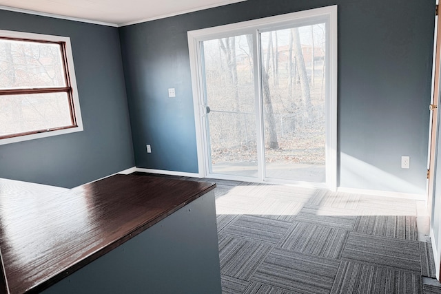 carpeted empty room featuring baseboards