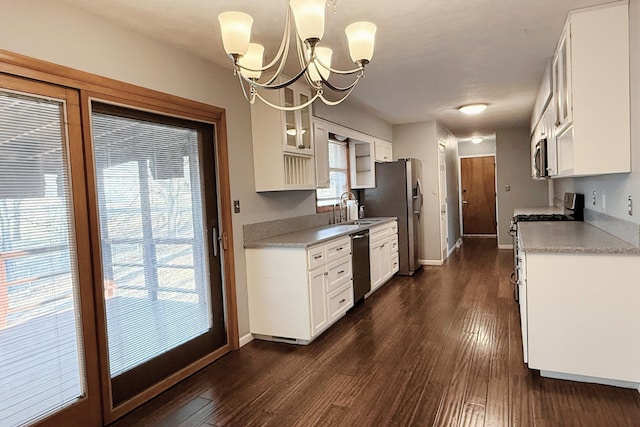 kitchen with baseboards, appliances with stainless steel finishes, dark wood finished floors, and white cabinetry