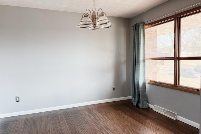 unfurnished room with a chandelier, visible vents, dark wood-type flooring, and baseboards