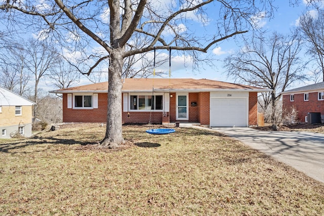 ranch-style home featuring a front yard, central AC unit, an attached garage, concrete driveway, and brick siding