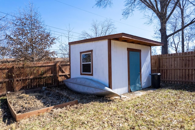 view of shed featuring a garden and a fenced backyard