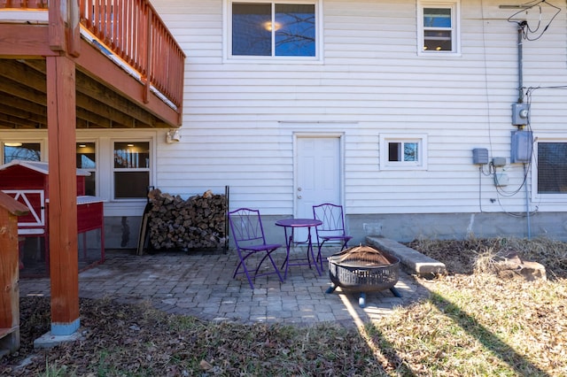 rear view of house featuring an outdoor fire pit and a patio area