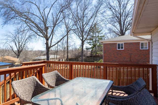 deck featuring outdoor dining area and fence