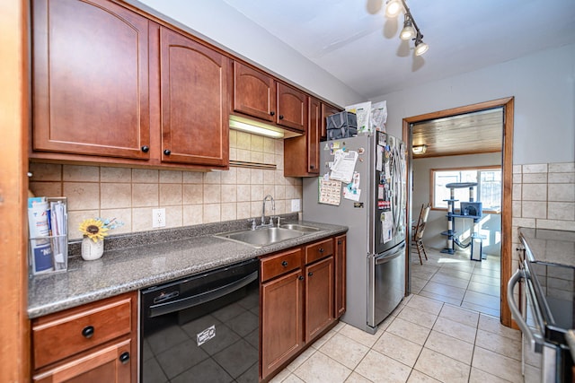 kitchen with dark countertops, electric range, black dishwasher, and a sink