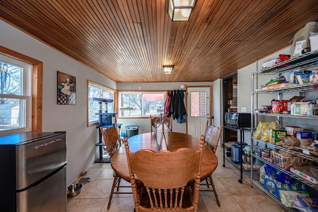 dining room featuring wooden ceiling and light tile patterned floors