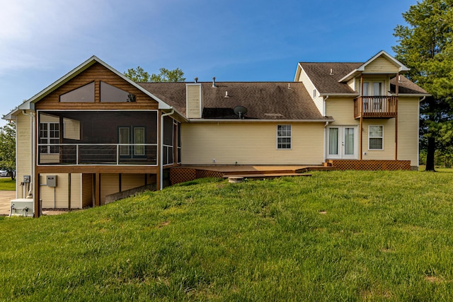 back of house with french doors, a chimney, a yard, and a sunroom