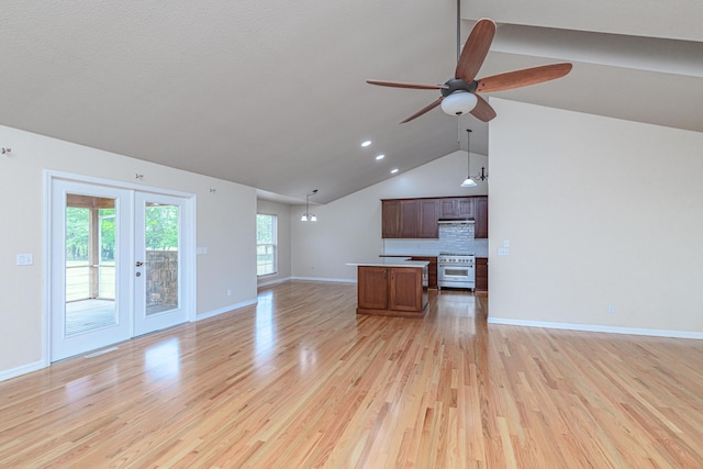 unfurnished living room featuring light wood-style flooring, french doors, baseboards, lofted ceiling, and ceiling fan