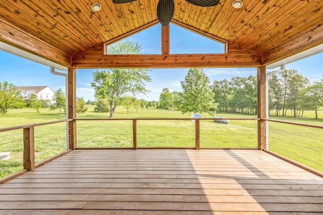 wooden deck featuring a lawn