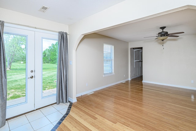 interior space featuring visible vents, french doors, light wood finished floors, baseboards, and ceiling fan