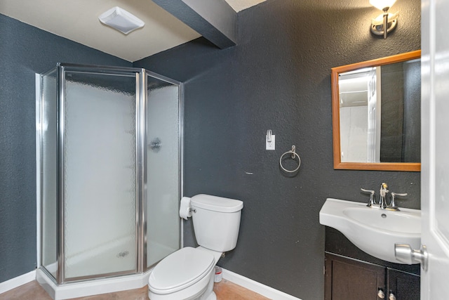 full bath with baseboards, vanity, toilet, and a shower stall