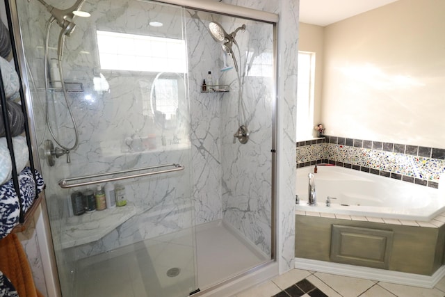 bathroom with a garden tub and a marble finish shower