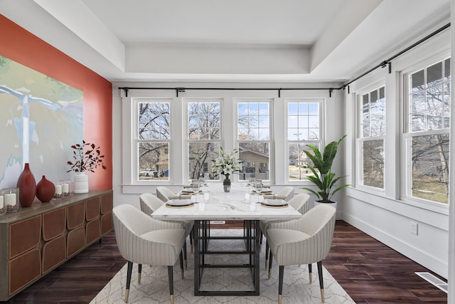 dining space featuring dark wood finished floors and baseboards