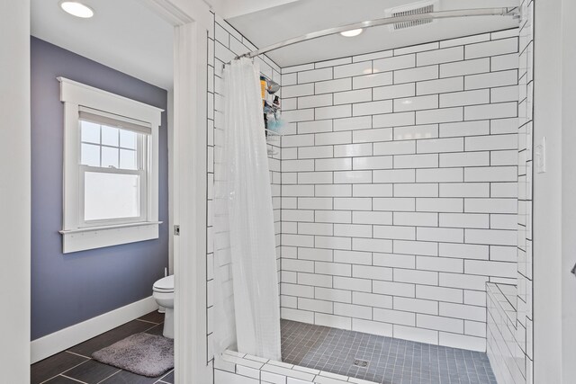 full bath featuring tile patterned flooring, visible vents, a shower stall, baseboards, and toilet