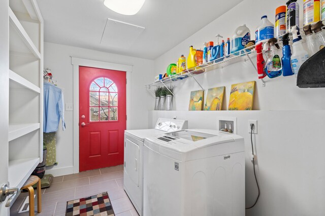 washroom featuring laundry area, attic access, light tile patterned floors, and separate washer and dryer