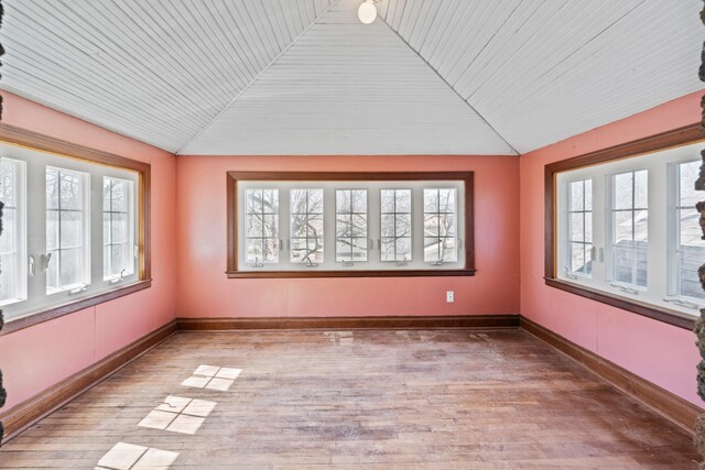 unfurnished sunroom featuring plenty of natural light, wooden ceiling, and lofted ceiling