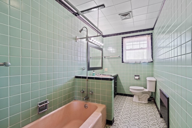 full bath featuring visible vents, toilet, tile walls, and vanity