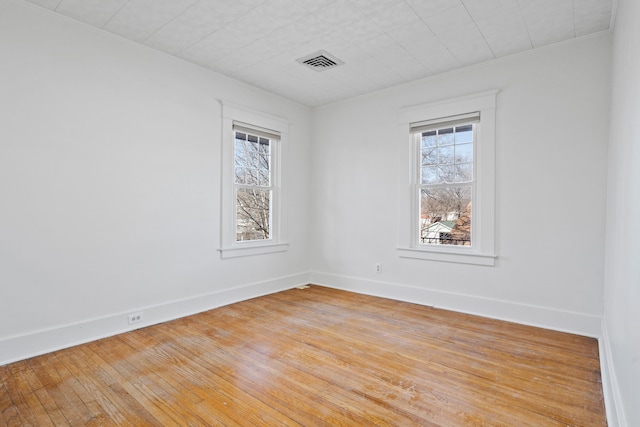 unfurnished room with visible vents, baseboards, and light wood finished floors