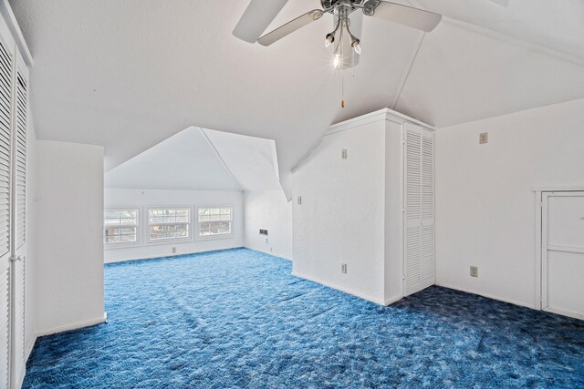 bonus room with vaulted ceiling, ceiling fan, and carpet floors