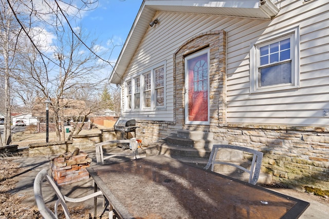 view of patio with area for grilling and entry steps