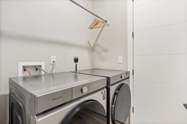 40 US Pl Unit 2B, Sunrise Beach, MO 65079 - washroom with laundry area, wood finished floors, a textured wall, and washer and clothes dryer