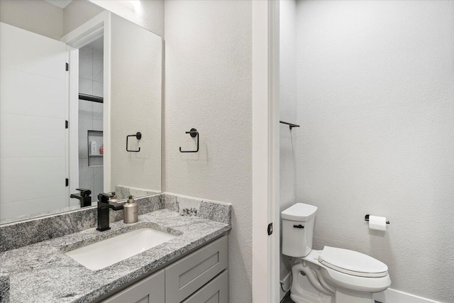 40 US Pl Unit 2B, Sunrise Beach, MO 65079 - bathroom with toilet, vanity, and a textured wall