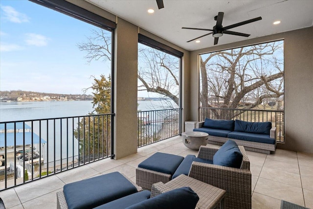 40 US Pl Unit 2B, Sunrise Beach, MO 65079 - sunroom / solarium with plenty of natural light, ceiling fan, and a water view