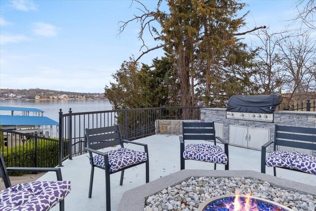 40 US Pl Unit 2B, Sunrise Beach, MO 65079 - view of patio / terrace featuring grilling area, an outdoor fire pit, a water view, and area for grilling