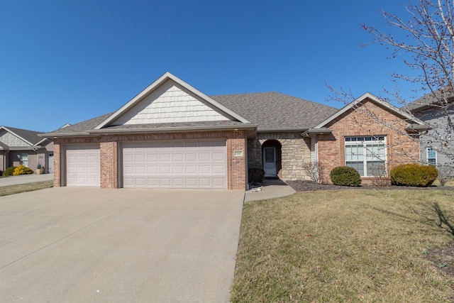 view of front of house with driveway, roof with shingles, a front yard, a garage, and brick siding