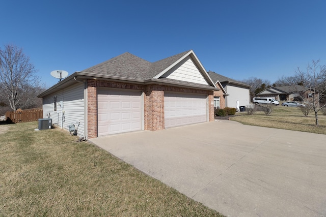 view of side of property featuring driveway, a yard, a garage, central air condition unit, and brick siding