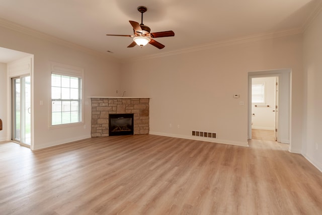 unfurnished living room with crown molding, ceiling fan, visible vents, and light wood-type flooring