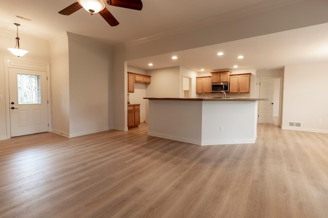 unfurnished living room with ceiling fan, visible vents, and light wood-type flooring