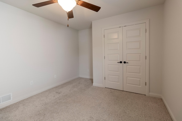 unfurnished room with visible vents, a ceiling fan, carpet, and baseboards