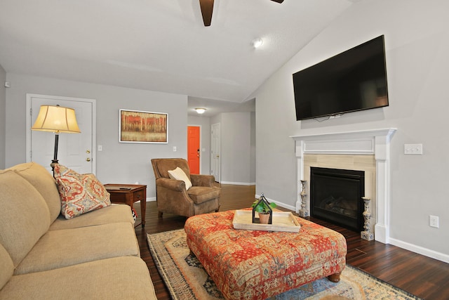 living room featuring dark wood-type flooring, baseboards, and vaulted ceiling