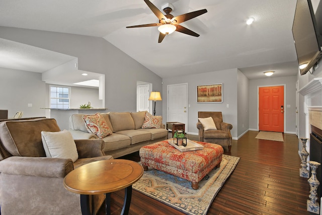 living room featuring dark wood finished floors, a fireplace, baseboards, ceiling fan, and vaulted ceiling