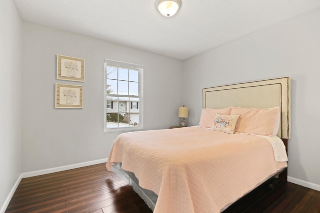 bedroom with baseboards and wood-type flooring