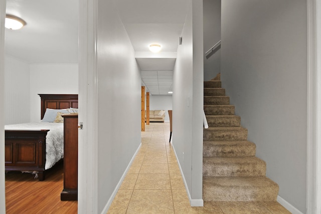 stairway with tile patterned flooring and baseboards