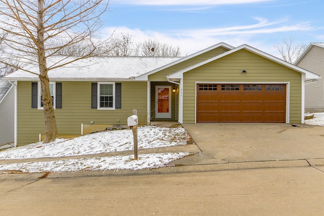 ranch-style house with a garage and driveway