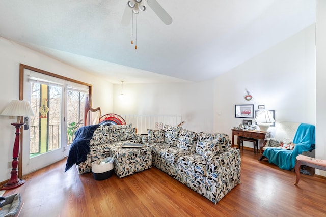 living room featuring ceiling fan, lofted ceiling, and wood finished floors