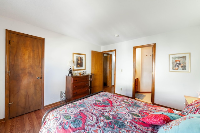 bedroom with wood finished floors and baseboards