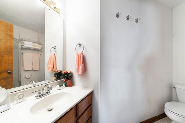 bathroom featuring toilet and vanity