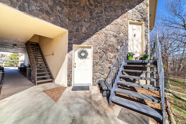 property entrance with stone siding