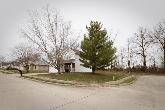 view of front of property with a garage, driveway, and a front yard