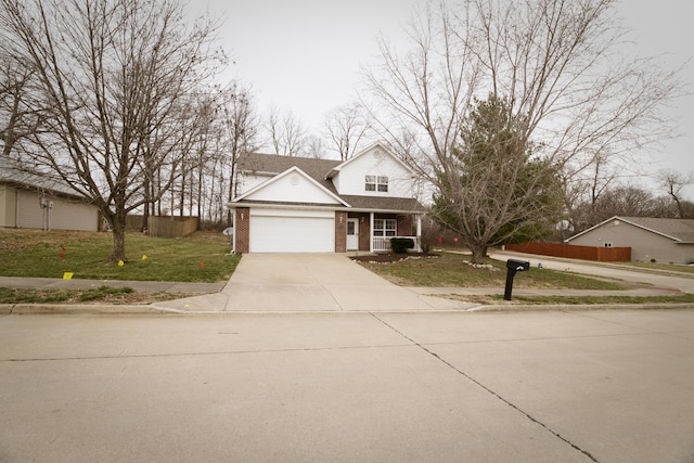 traditional home featuring brick siding, fence, concrete driveway, a front yard, and an attached garage